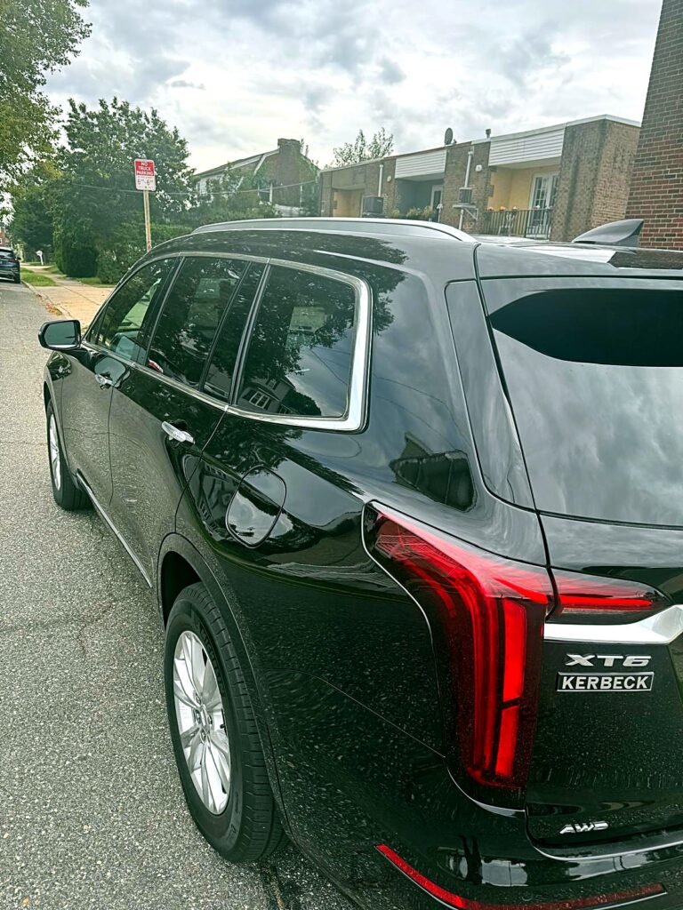 Black Cadillac XT6 rear view with LED taillights for luxury airport transportation in Philadelphia.