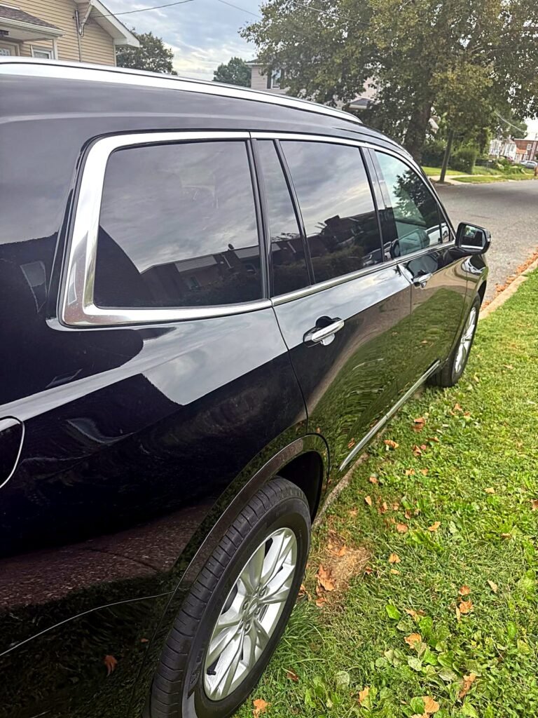 Black Cadillac XT6 side profile with tinted windows for private chauffeur service in Philadelphia.