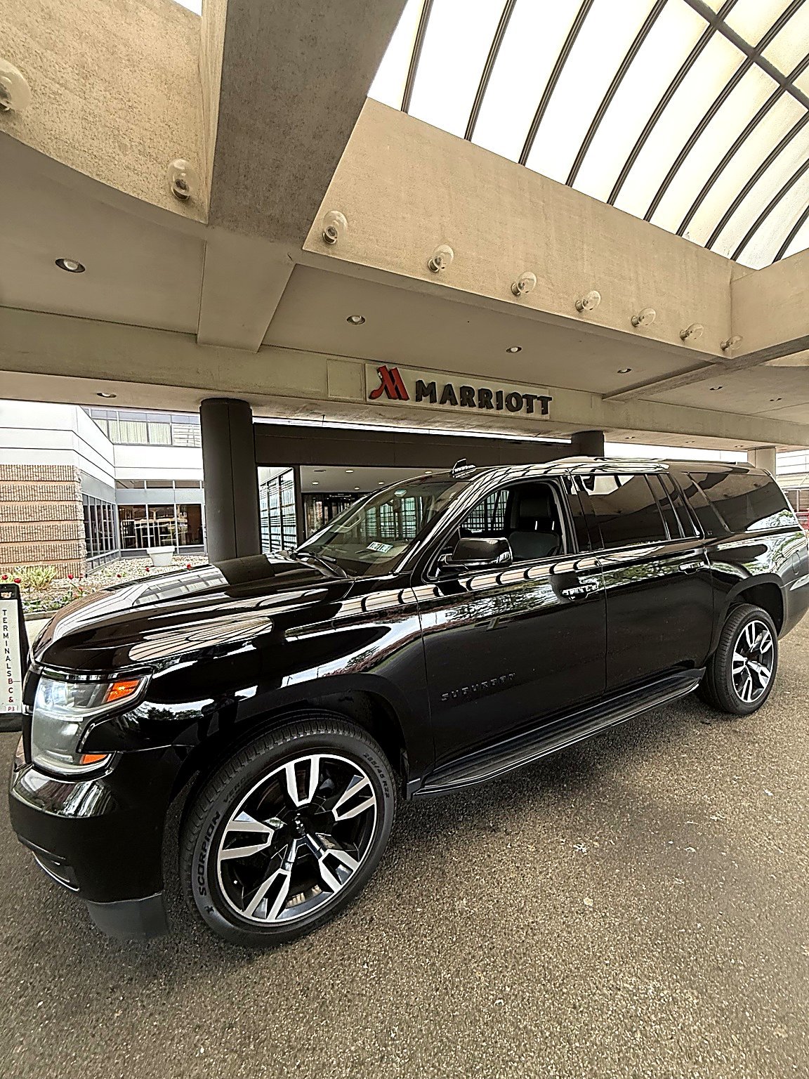 Black SUV parked at a Marriott hotel entrance