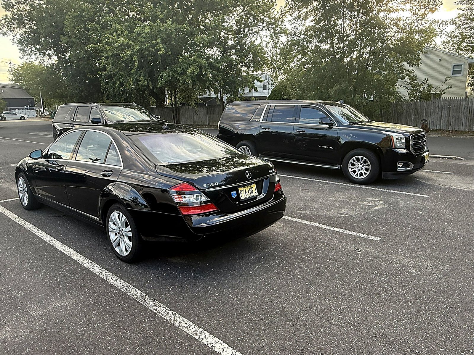 Black luxury sedans parked