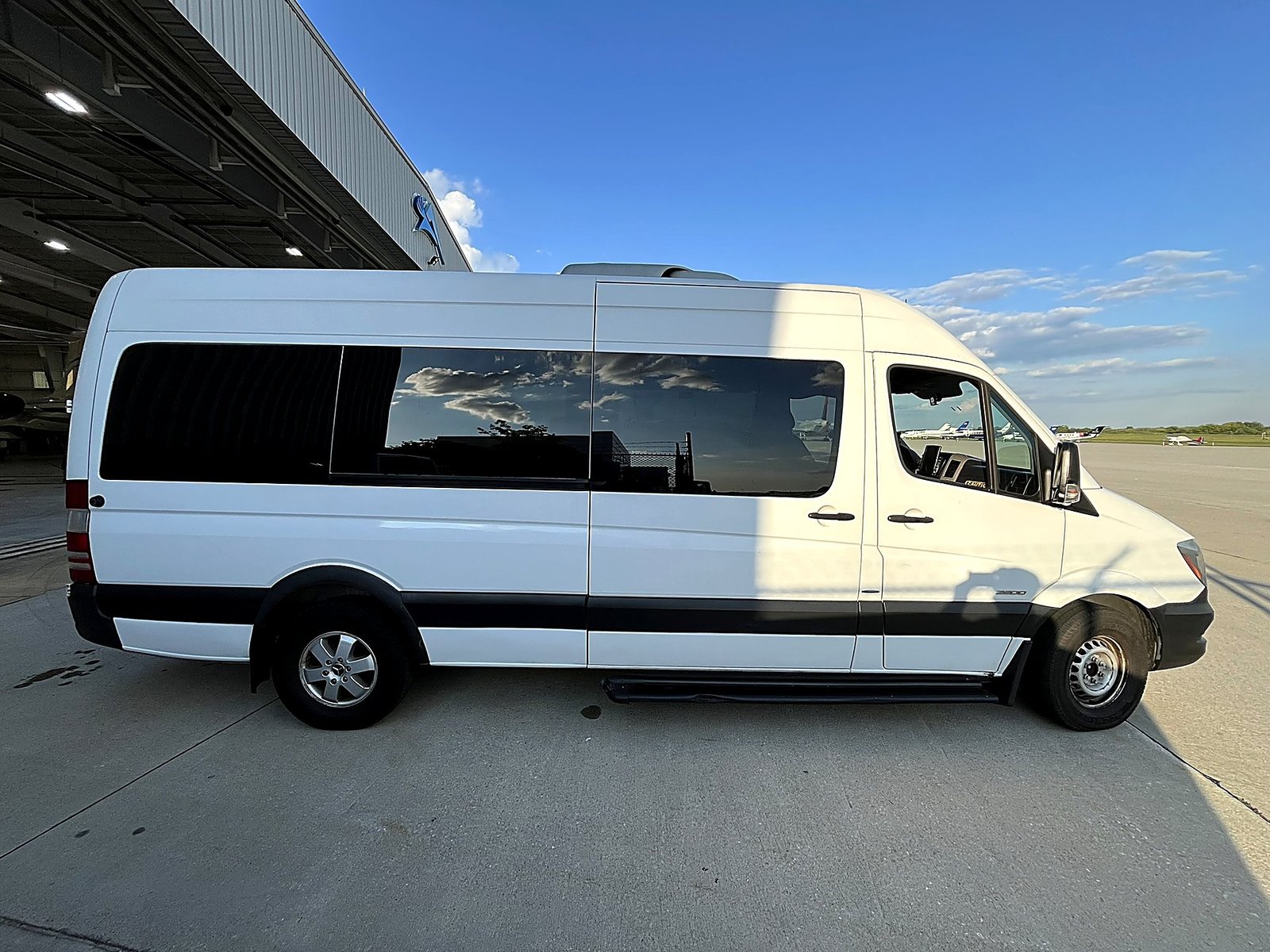 White Mercedes-Benz Sprinter van at Philadelphia International Airport for group airport transfers.