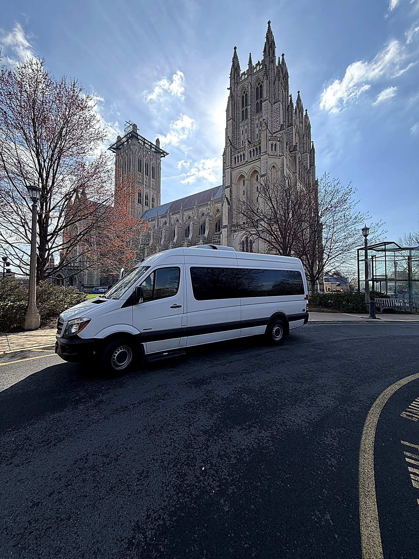 White Sprinter van parked in front of a Gothic cathedral