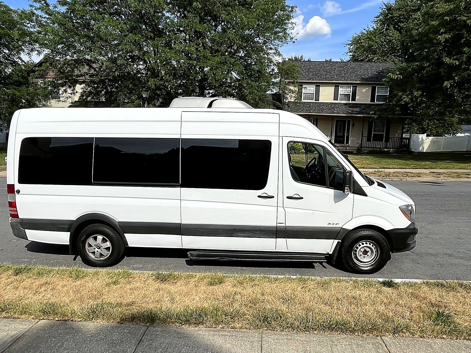 White Sprinter van parked on a residential street