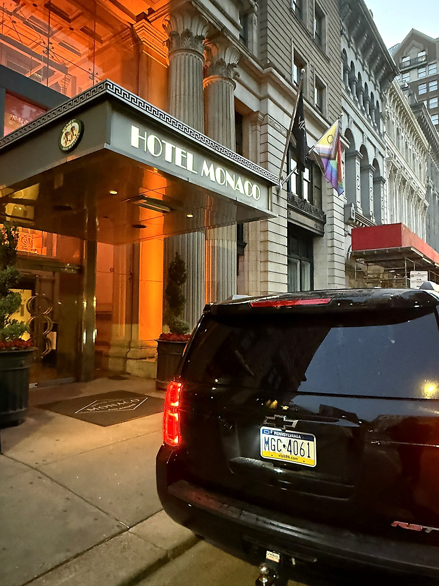 Black SUV parked outside the Hotel Monaco entrance at night